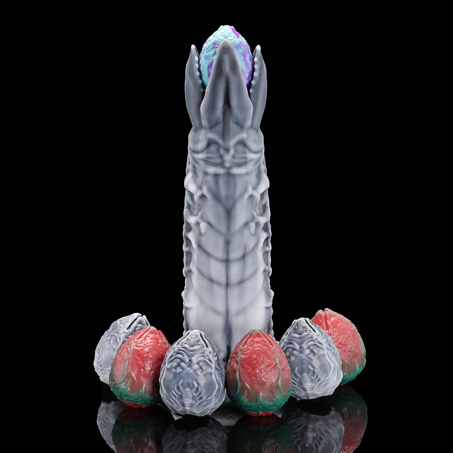 Marbled and metallic adult toy eggs insertable for egg laying kink play.