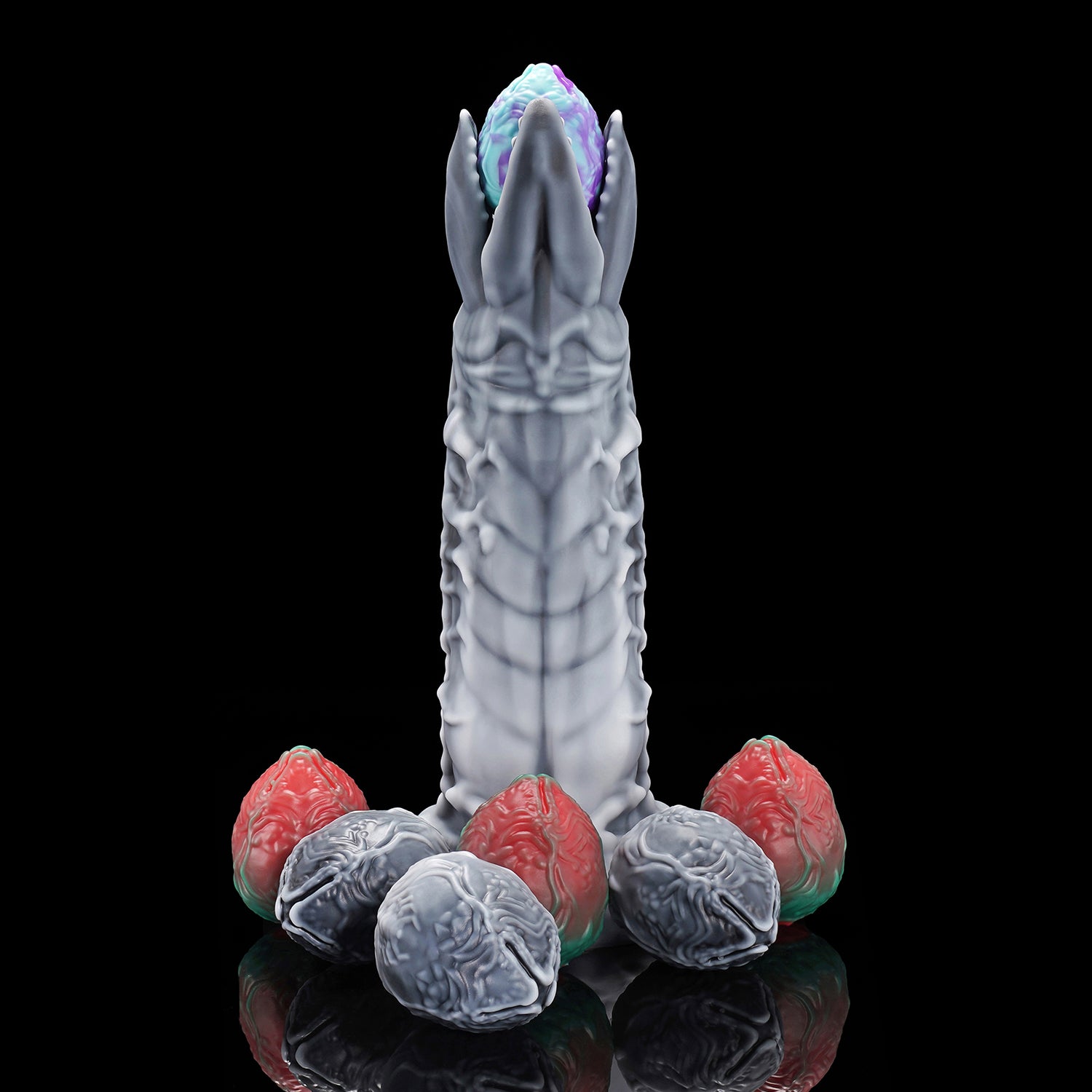 Marbled and metallic adult toy eggs insertable for egg laying kink play.
