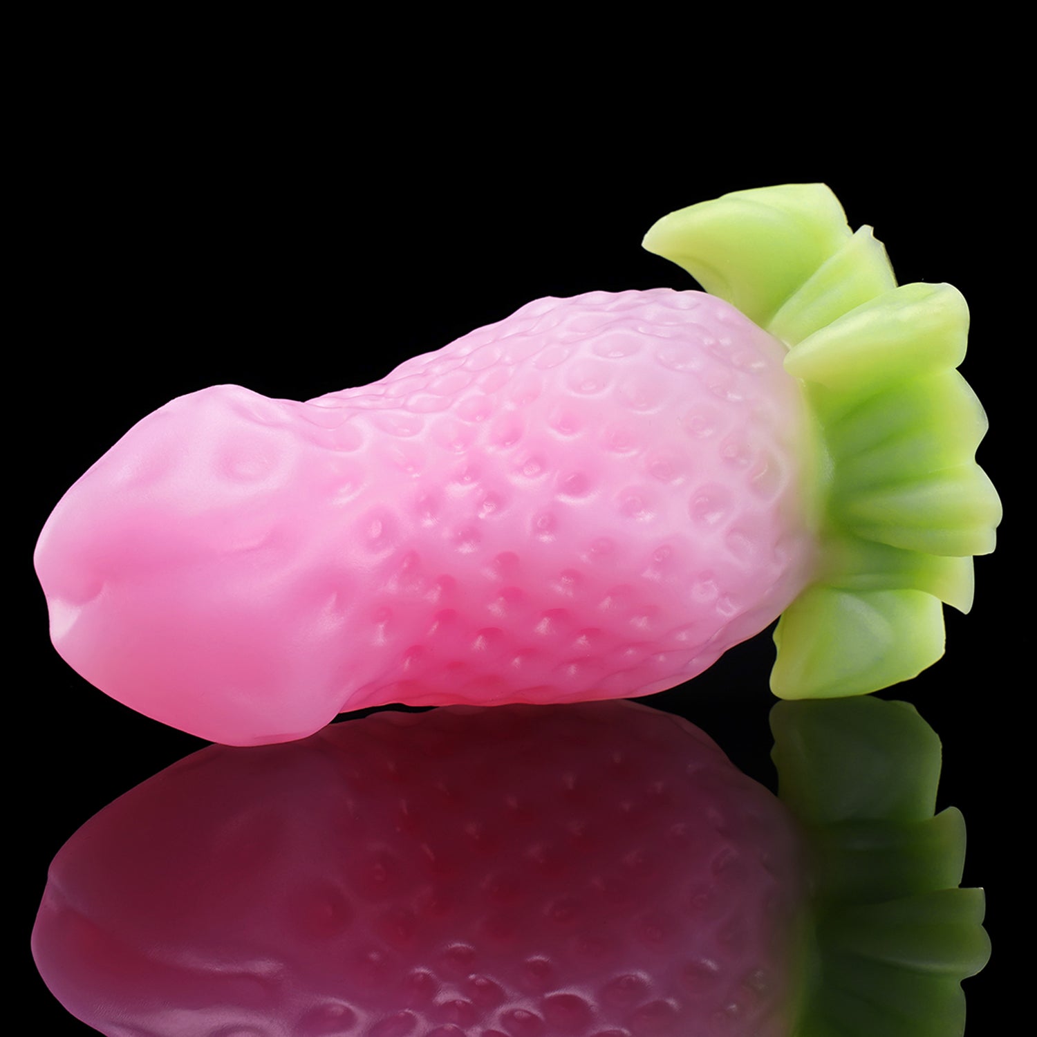 BERRYBLOOM fantasy strawberry butt plug with seed texture, leafy base, and rounded tip - pink custom color angled view
